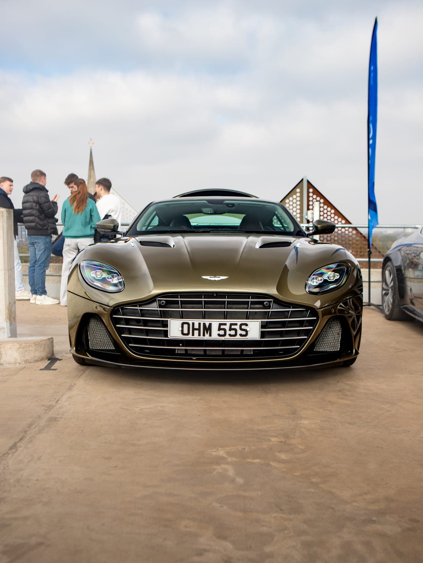 People gathered around a private plate car at an event